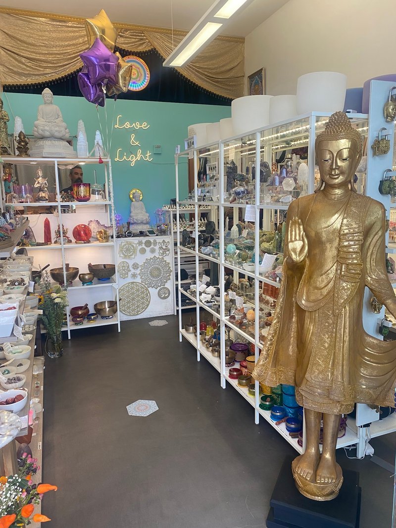 Amaloa Healing Arts' interior containing buddah statues, bowls, and crystals