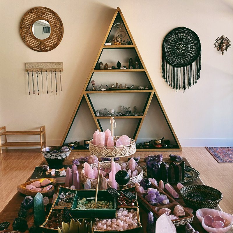 Display table with rose quartz, amethyst, and other crystals