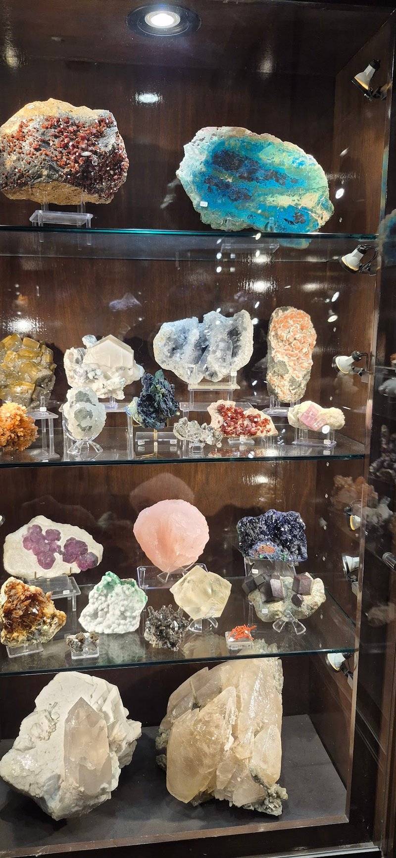 Shelving display featuring amethyst, quartz, and various crystal specimens