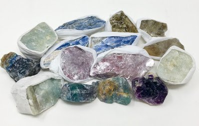 Jewelry display stand with crystal bracelets, raw selenite pieces, and tumbled stones