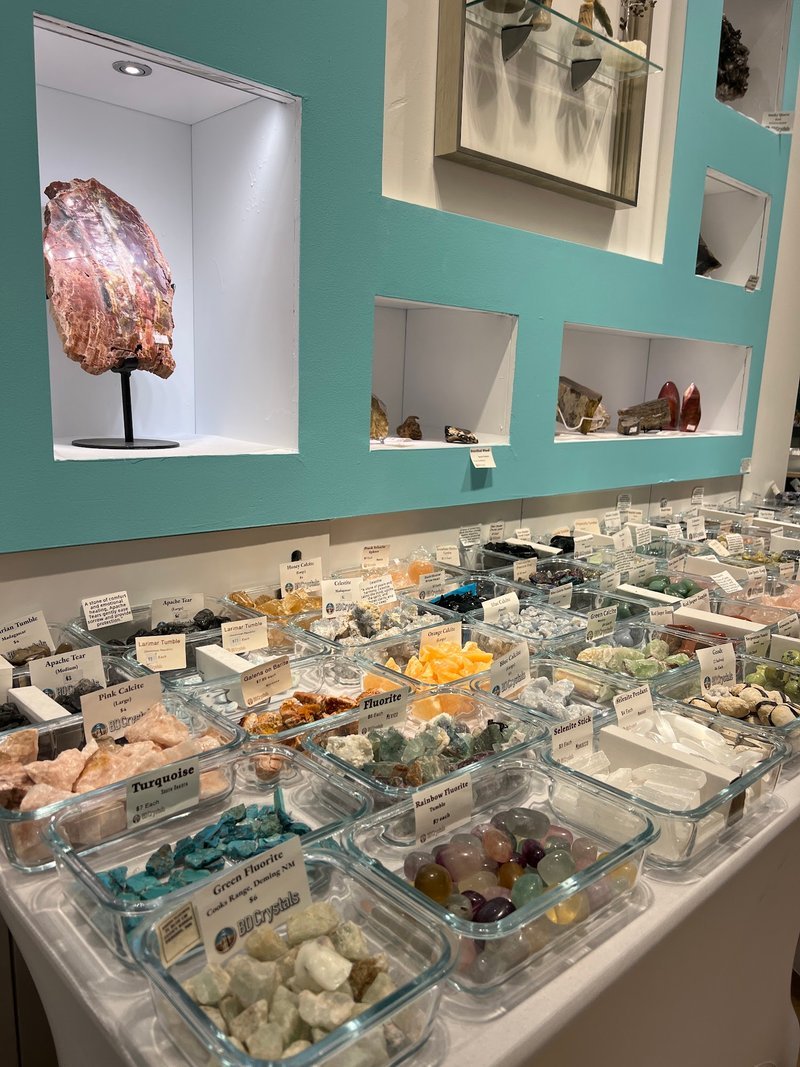 Retail display with tumbled stones, raw crystals, and polished specimens