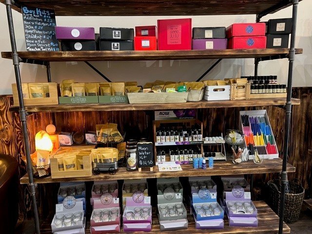 Shelving display featuring amethyst, quartz, and various crystal specimens