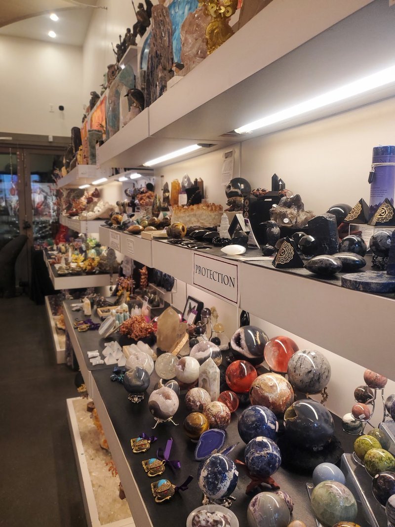 Shop interior featuring gemstones, healing crystals, and spiritual products