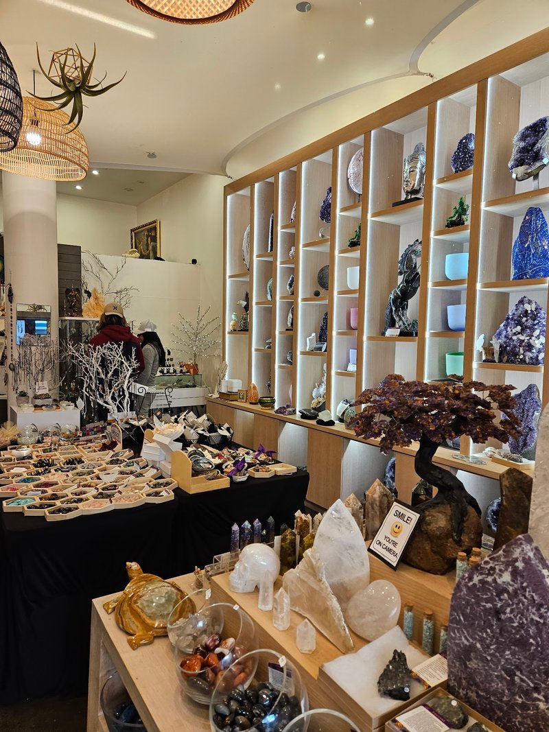 Display featuring crystal points, polished stones, and raw mineral specimens