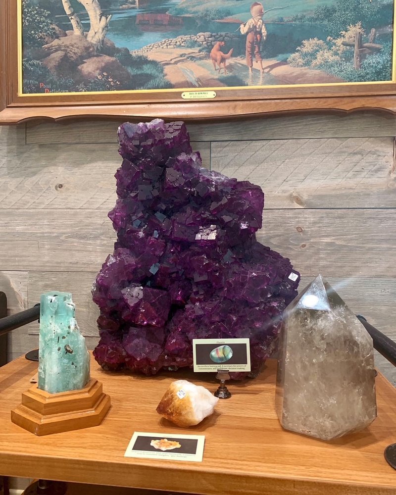 Variety of gemstones, crystal carvings, and polished mineral specimens
