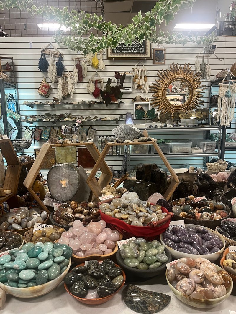 Collection of tumbled stones, raw minerals, and crystal clusters