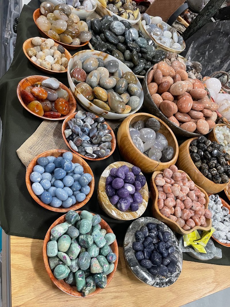 Selection of healing crystals, tumbled stones, and decorative mineral pieces