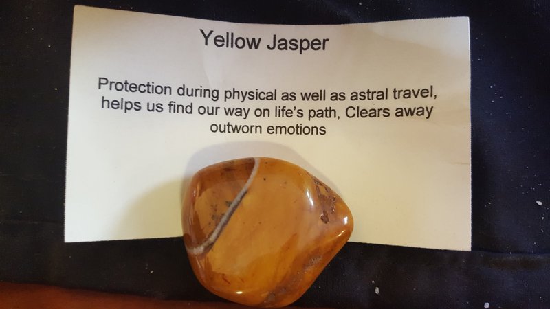 Shelving display featuring amethyst, quartz, and various crystal specimens