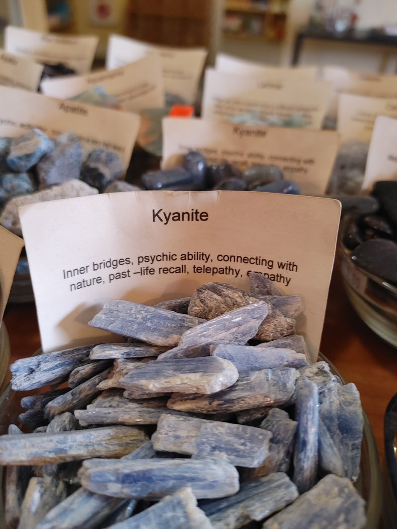 Display featuring crystal points, polished stones, and raw mineral specimens