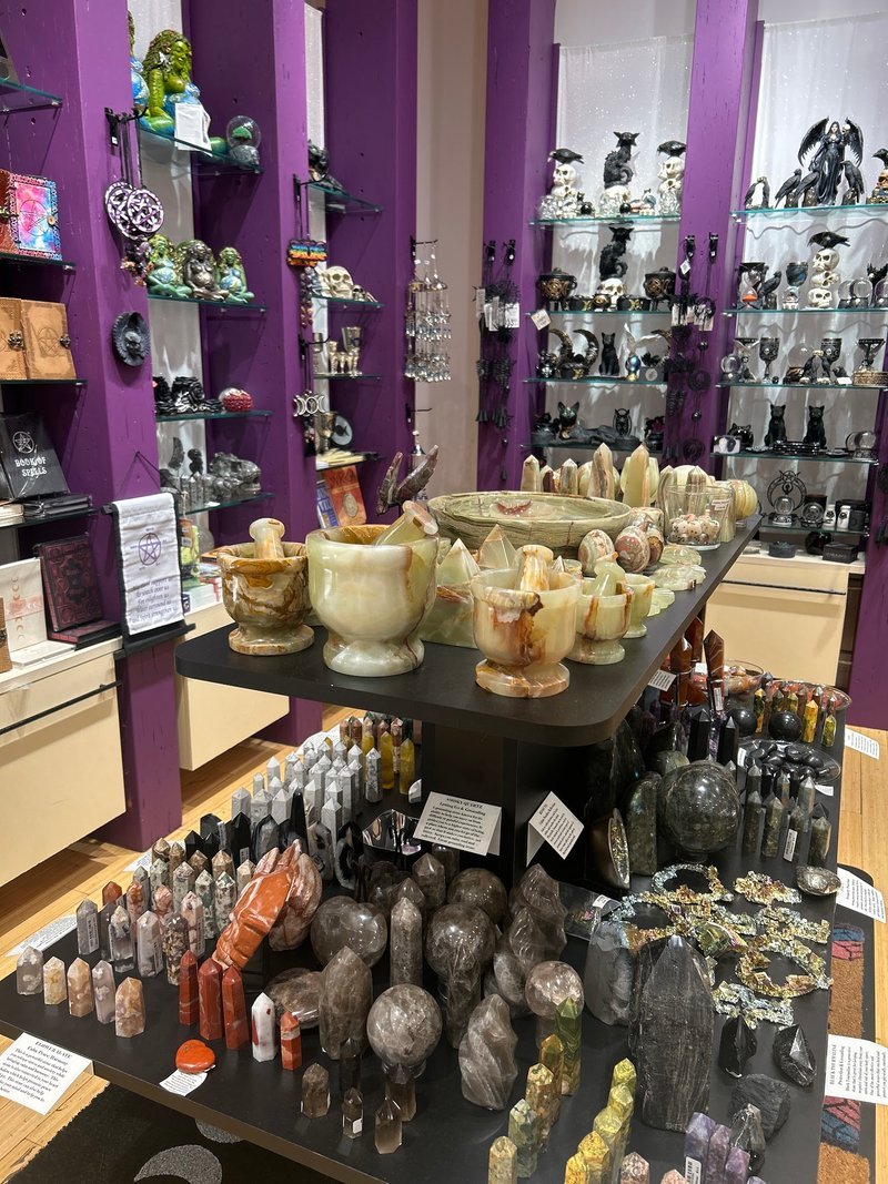 Display featuring crystal points, polished stones, and raw mineral specimens