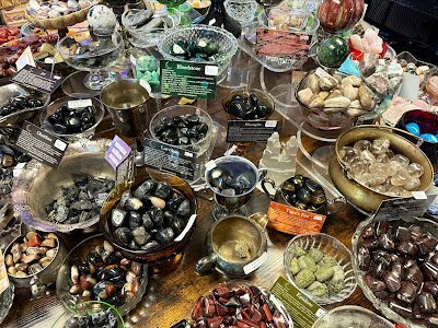 Shelving display featuring amethyst, quartz, and various crystal specimens