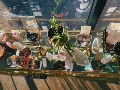 Shelving featuring chakra stones, healing crystals, and mineral specimens