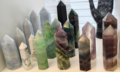 Crystal and mineral specimens including quartz, amethyst, and calcite varieties