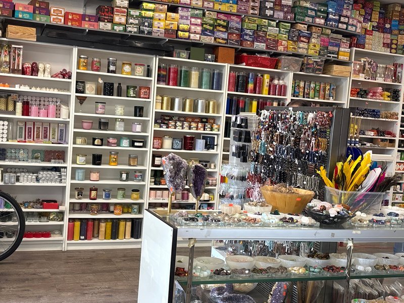 Retail shelving with organized crystals, stones, and spiritual products