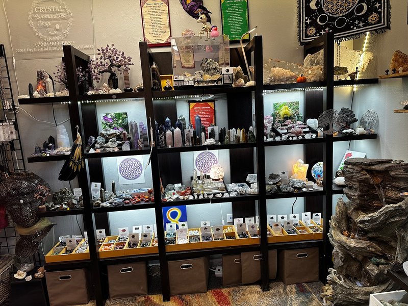 Variety of gemstones, crystal carvings, and polished mineral specimens