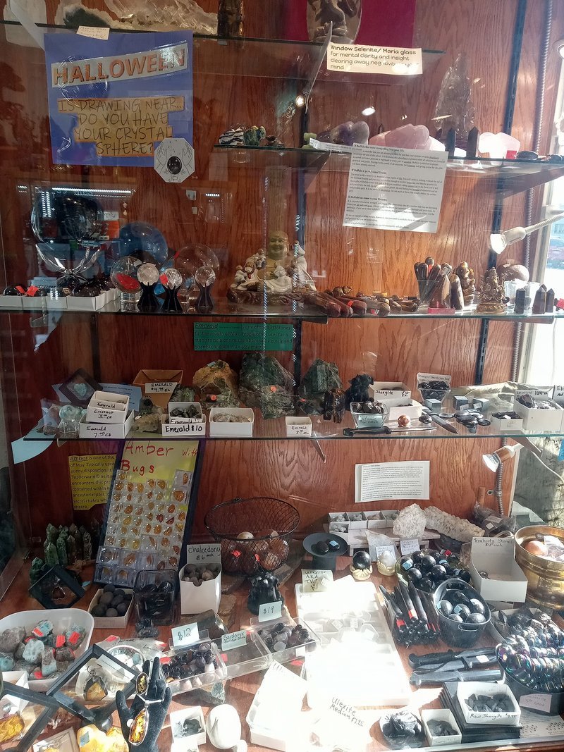 Variety of gemstones, crystal carvings, and polished mineral specimens