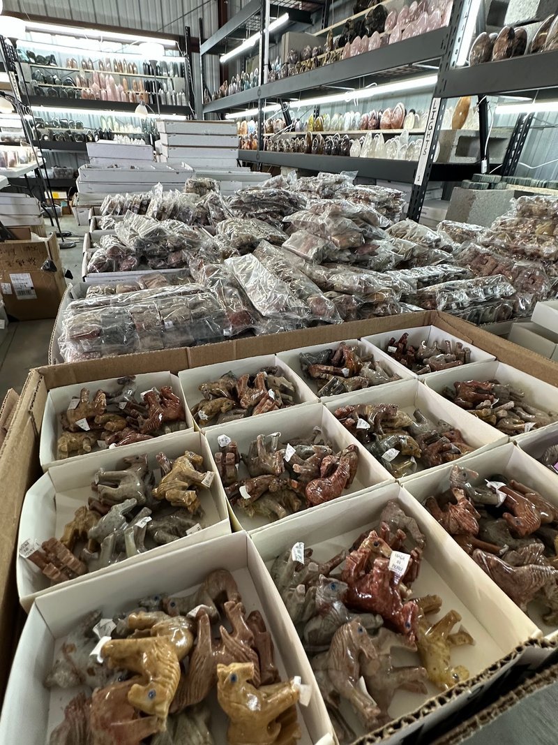 Display featuring crystal points, polished stones, and raw mineral specimens