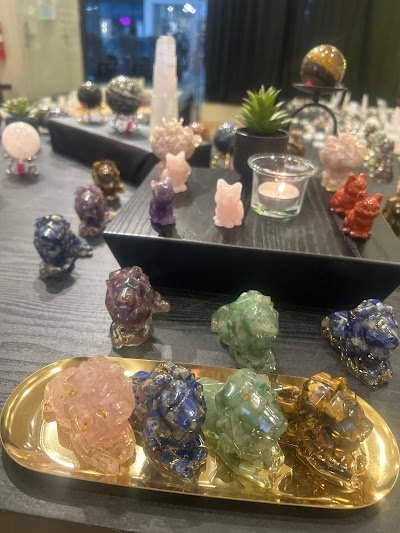 Spiritual altar arrangement with crystal specimens, rose quartz tower, amethyst sphere, and candles