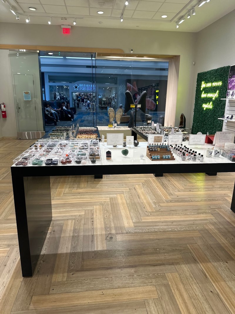 Variety of gemstones, crystal carvings, and polished mineral specimens