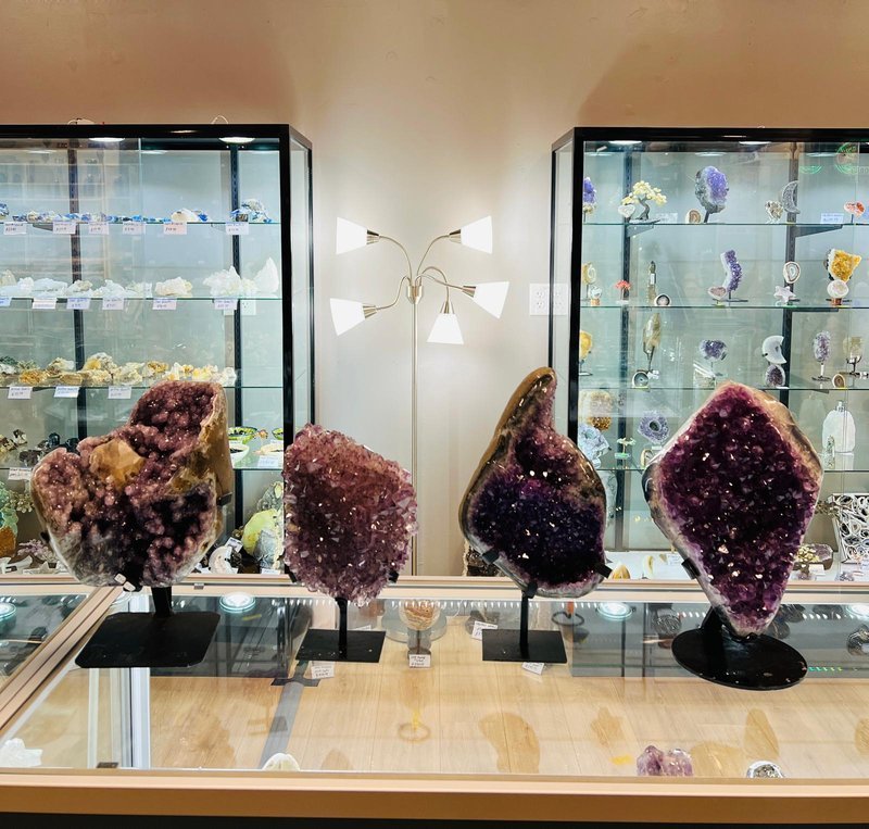 Display featuring crystal points, polished stones, and raw mineral specimens
