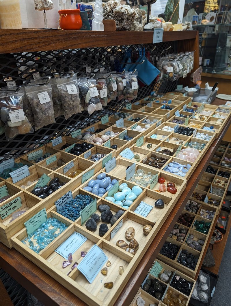 Collection of tumbled stones, raw minerals, and crystal clusters