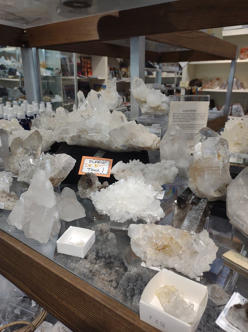 Collection of tumbled stones, raw minerals, and crystal clusters