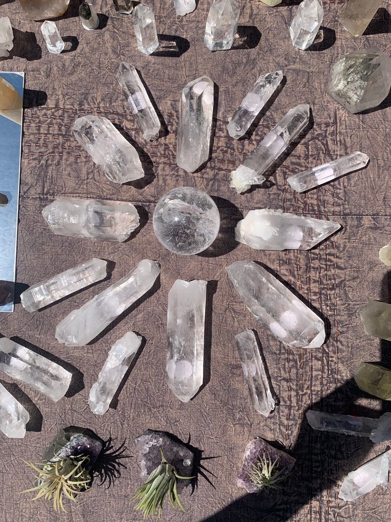 Variety of gemstones, crystal carvings, and polished mineral specimens