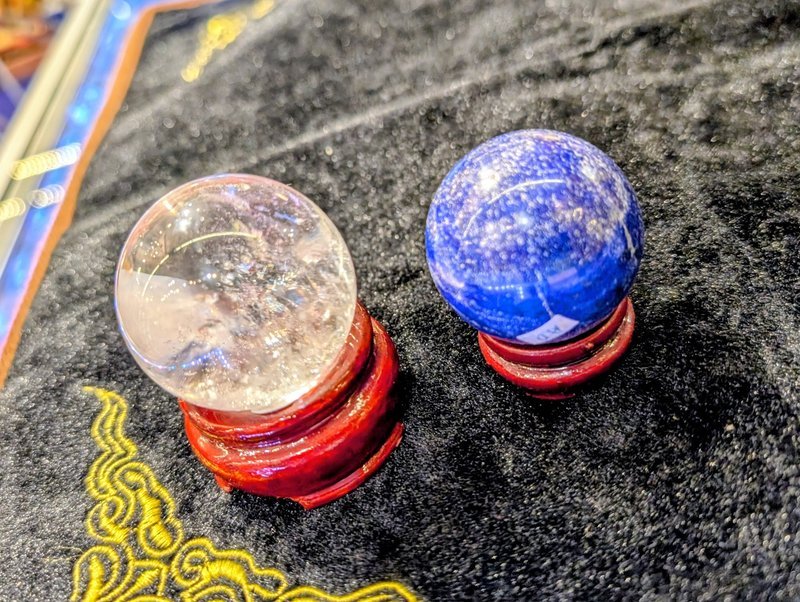 Variety of gemstones, crystal carvings, and polished mineral specimens