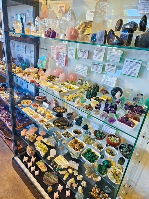 Display of polished crystal specimens, geodes, and mineral towers