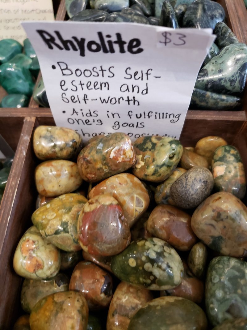 Collection of tumbled stones, raw minerals, and crystal clusters