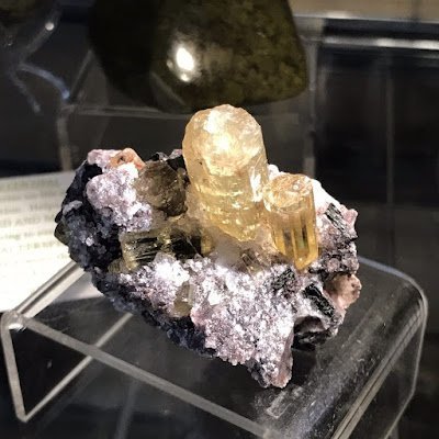 Display featuring crystal points, polished stones, and raw mineral specimens