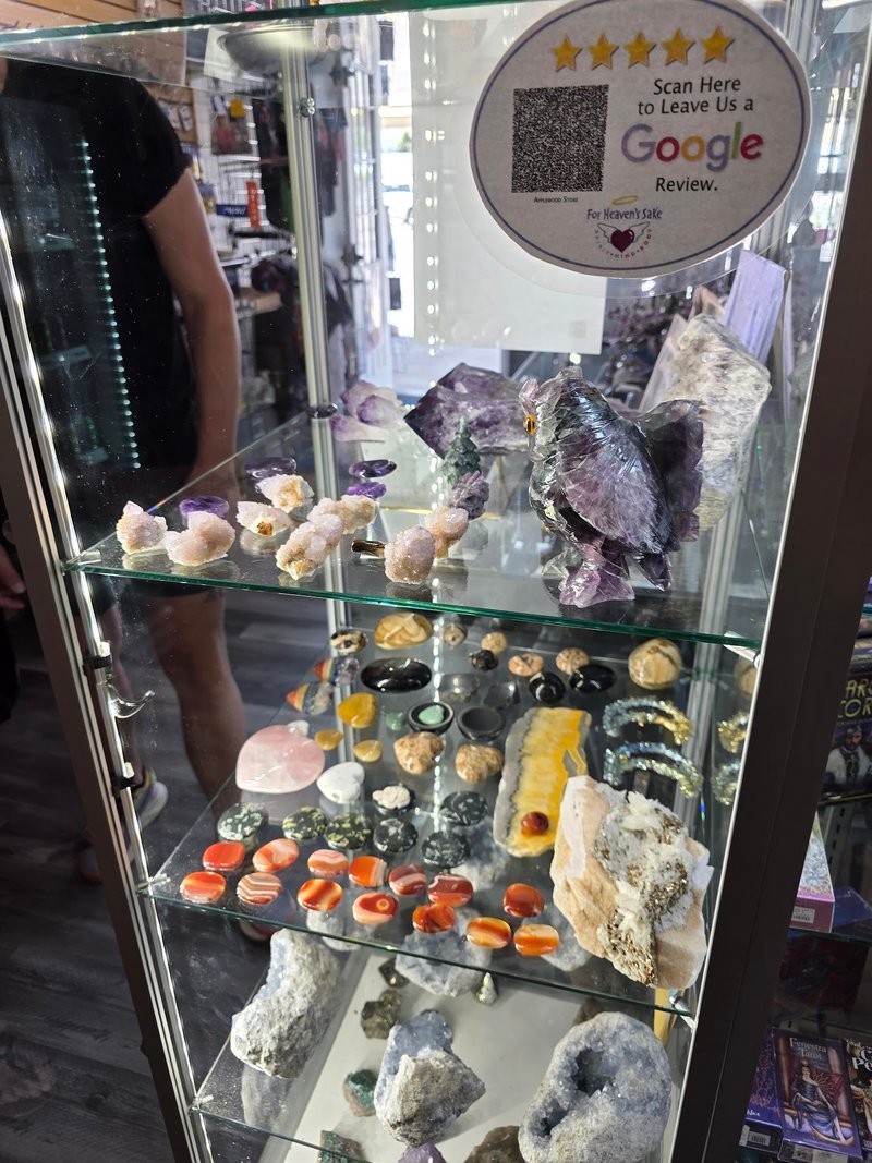 Display featuring crystal points, polished stones, and raw mineral specimens