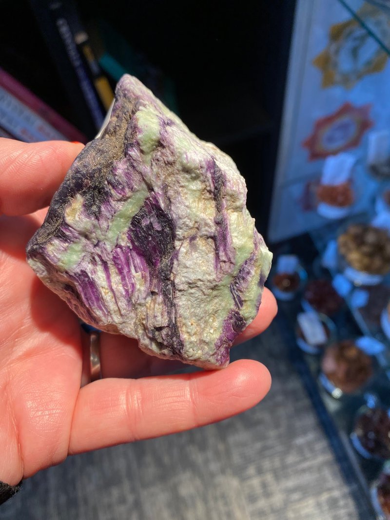 Retail shelving with organized crystals, stones, and spiritual products