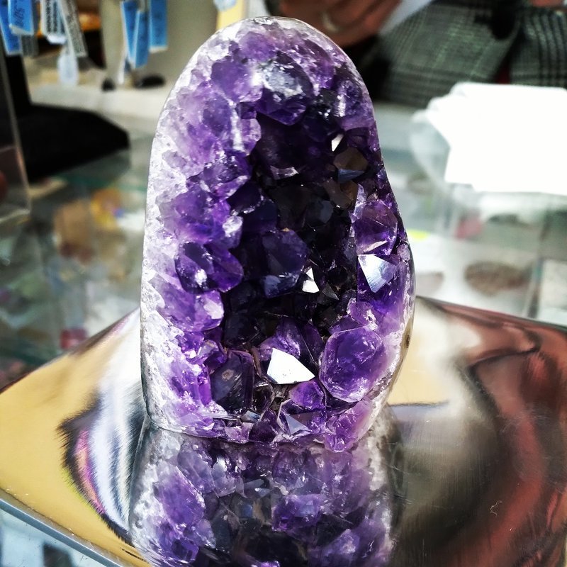 Shelving display featuring amethyst, quartz, and various crystal specimens