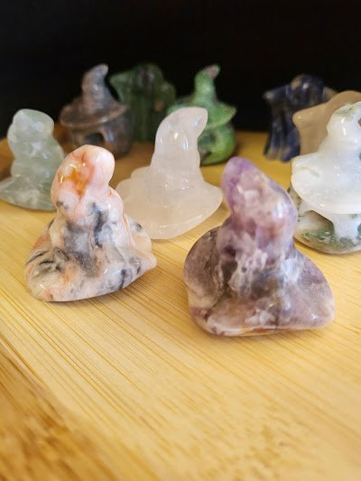 Shelving featuring chakra stones, healing crystals, and mineral specimens