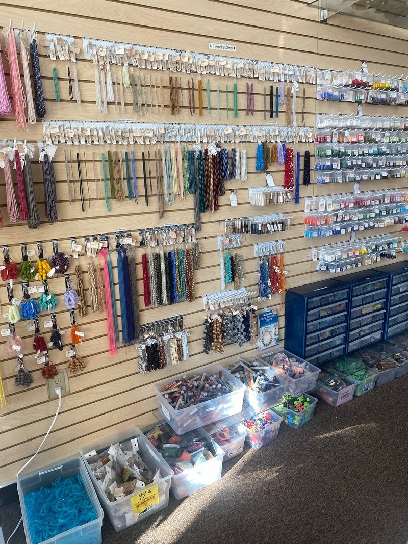 Shelving display featuring amethyst, quartz, and various crystal specimens