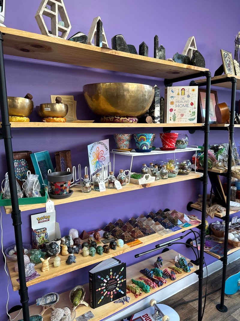 Eclectic bookstore interior with vintage furniture, bookshelves, and metaphysical crystal displays