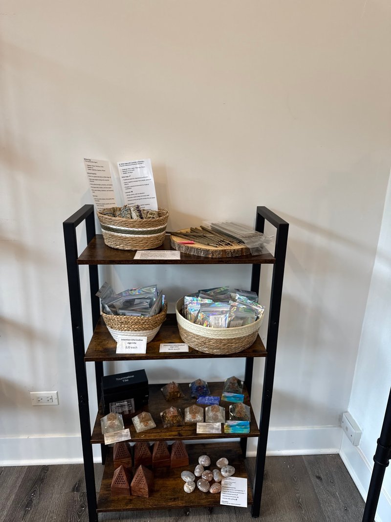 Atmospheric shop interior with exposed ductwork, antique furniture, and curated mineral specimens