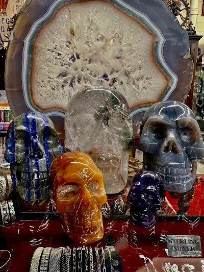 Shelving display featuring amethyst, quartz, and various crystal specimens