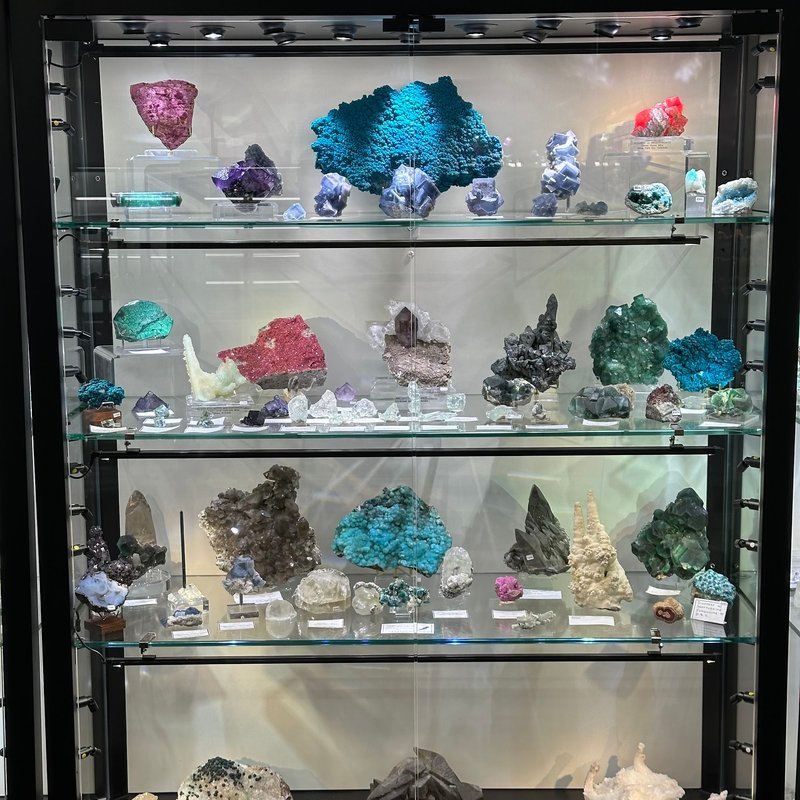 Display of polished crystal specimens, geodes, and mineral towers