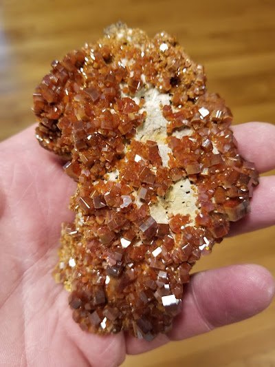 Display of crystal jewelry, tumbled stones, and carved gemstone pieces