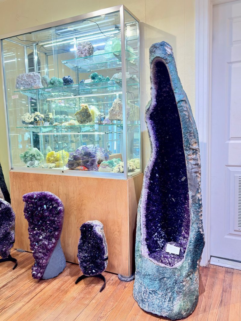Display of polished crystal specimens, geodes, and mineral towers