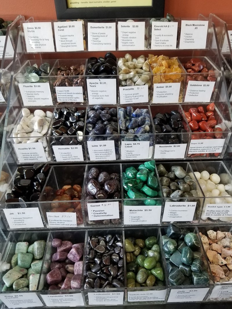 Collection of tumbled stones, raw minerals, and crystal clusters
