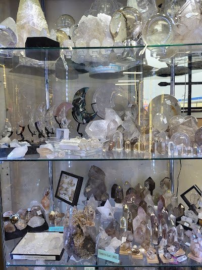 Display featuring crystal points, polished stones, and raw mineral specimens