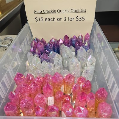 Display of crystal jewelry, tumbled stones, and carved gemstone pieces