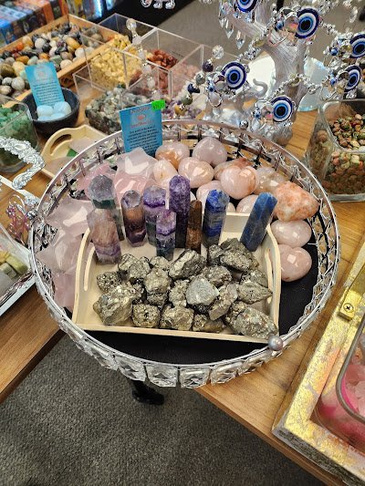Shelving featuring chakra stones, healing crystals, and mineral specimens
