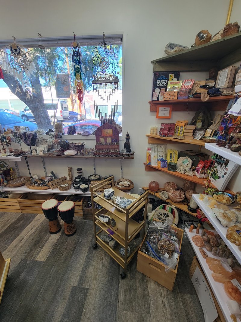 Shelving display featuring amethyst, quartz, and various crystal specimens