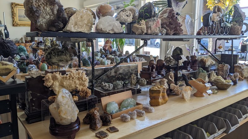 Variety of gemstones, crystal carvings, and polished mineral specimens