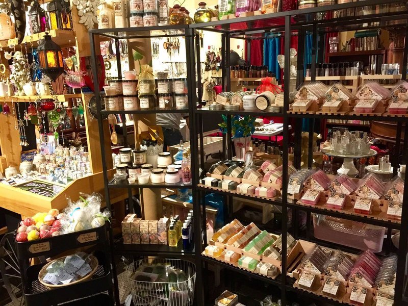 Shelving display featuring amethyst, quartz, and various crystal specimens
