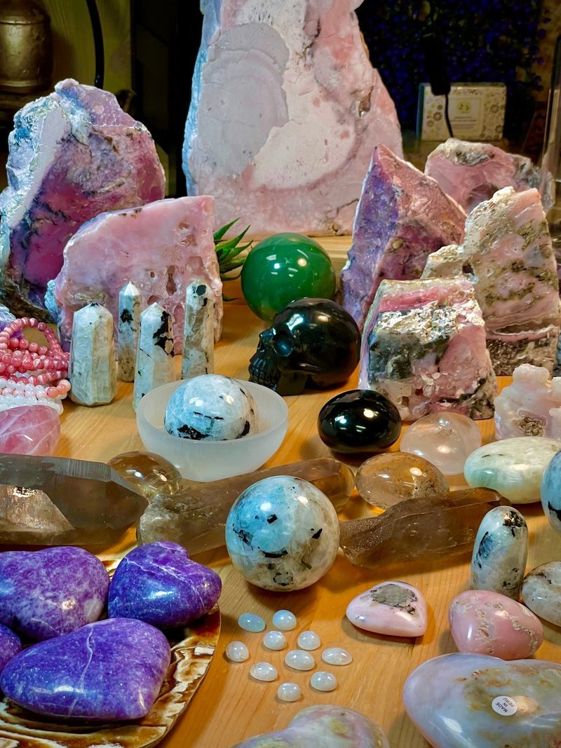 Variety of gemstones, crystal carvings, and polished mineral specimens